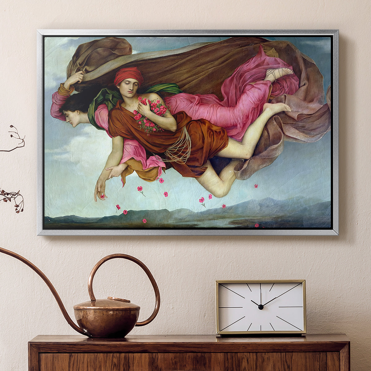 Silver floater framed canvas featuring a dreamlike scene with draped figures drifting across dark background, displayed above a cabinet in a soft-toned living room.