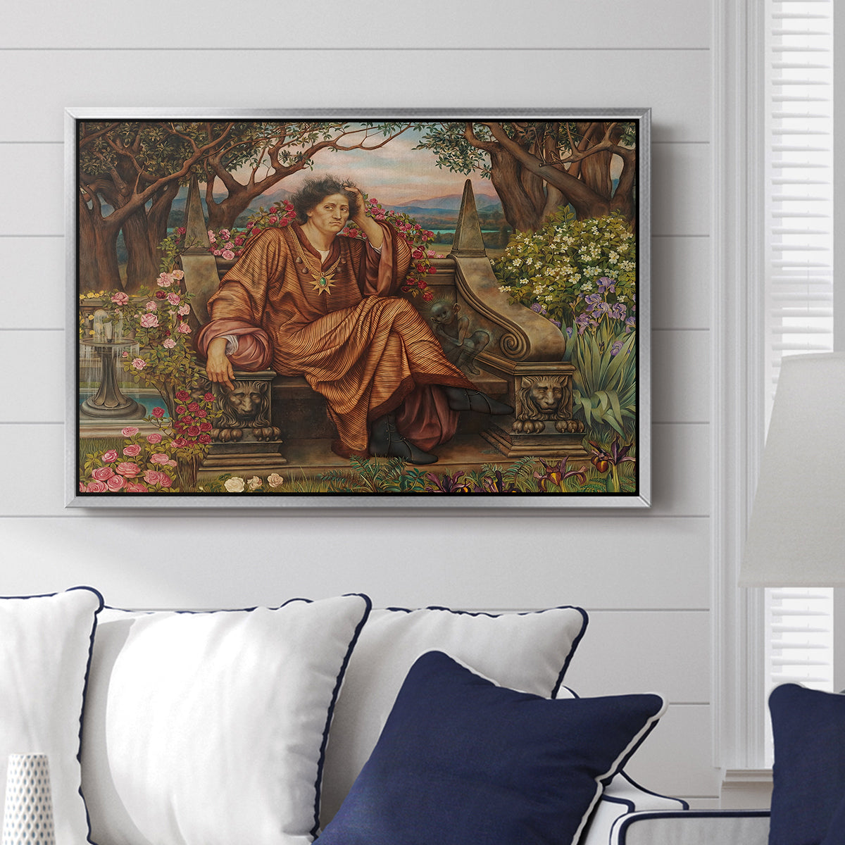 A Soul in Hell, c. 1901-1902 by Evelyn De Morgan displayed above a sofa in a living room in a silver floater frame, featuring a dramatic allegory of suffering with figure engulfed in fiery environment.