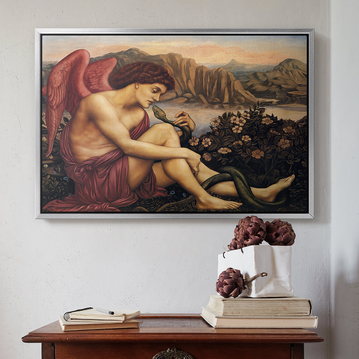 Silver floater framed canvas featuring The Angel with the Serpent, c. 1870-1875 by Evelyn De Morgan above an entryway table in a minimalist foyer.