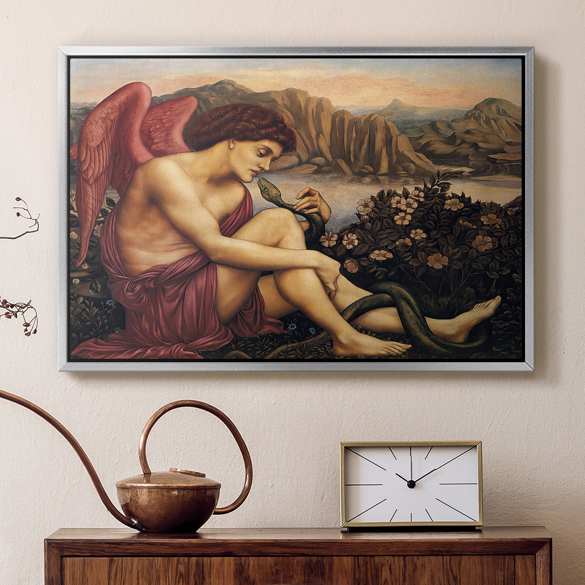 Silver floater framed canvas featuring a religious scene with angel defeating snake in dramatic pose, displayed above a cabinet in a soft-toned living room.