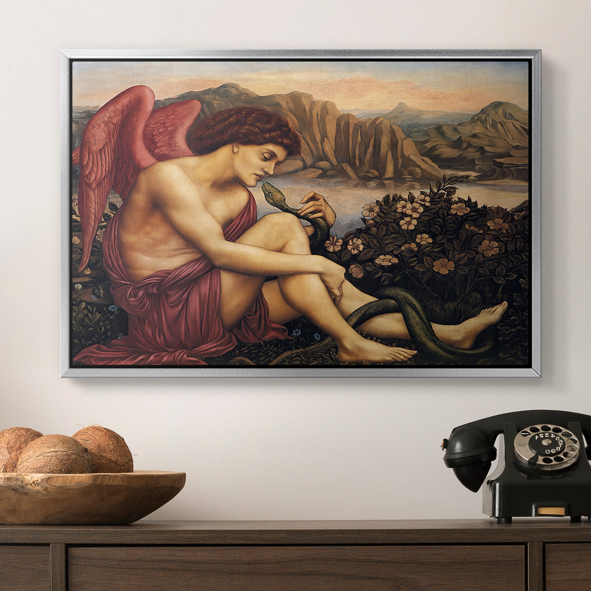 The Angel with the Serpent, c. 1870-1875 by Evelyn De Morgan in a silver floater framed canvas displayed above a console table in a hallway, featuring a symbolic imagery of purity overcoming evil forces.