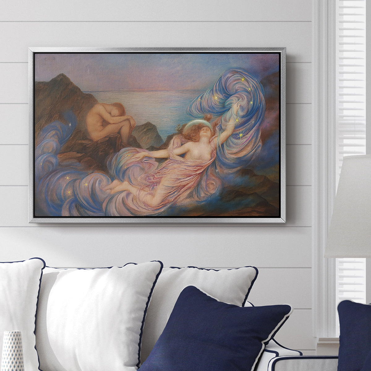 Twilight, 1914 by Evelyn De Morgan displayed above a sofa in a living room in a silver floater frame, featuring an allegorical figure resting in atmospheric dusk setting.