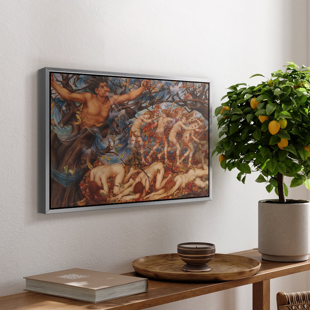 Boreas and the Fallen Leaves, c. 1910-1914 by Evelyn De Morgan, presented in a silver floater framed canvas featuring swirling figures carried by wind among falling leaves in dynamic composition, displayed above a hallway console table.
