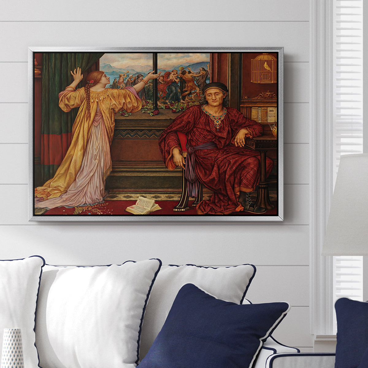 The Gilded Cage, c. 1901-1902 by Evelyn De Morgan displayed above a sofa in a living room in a silver floater frame, featuring a symbolic scene of figure enclosed within decorative surroundings.