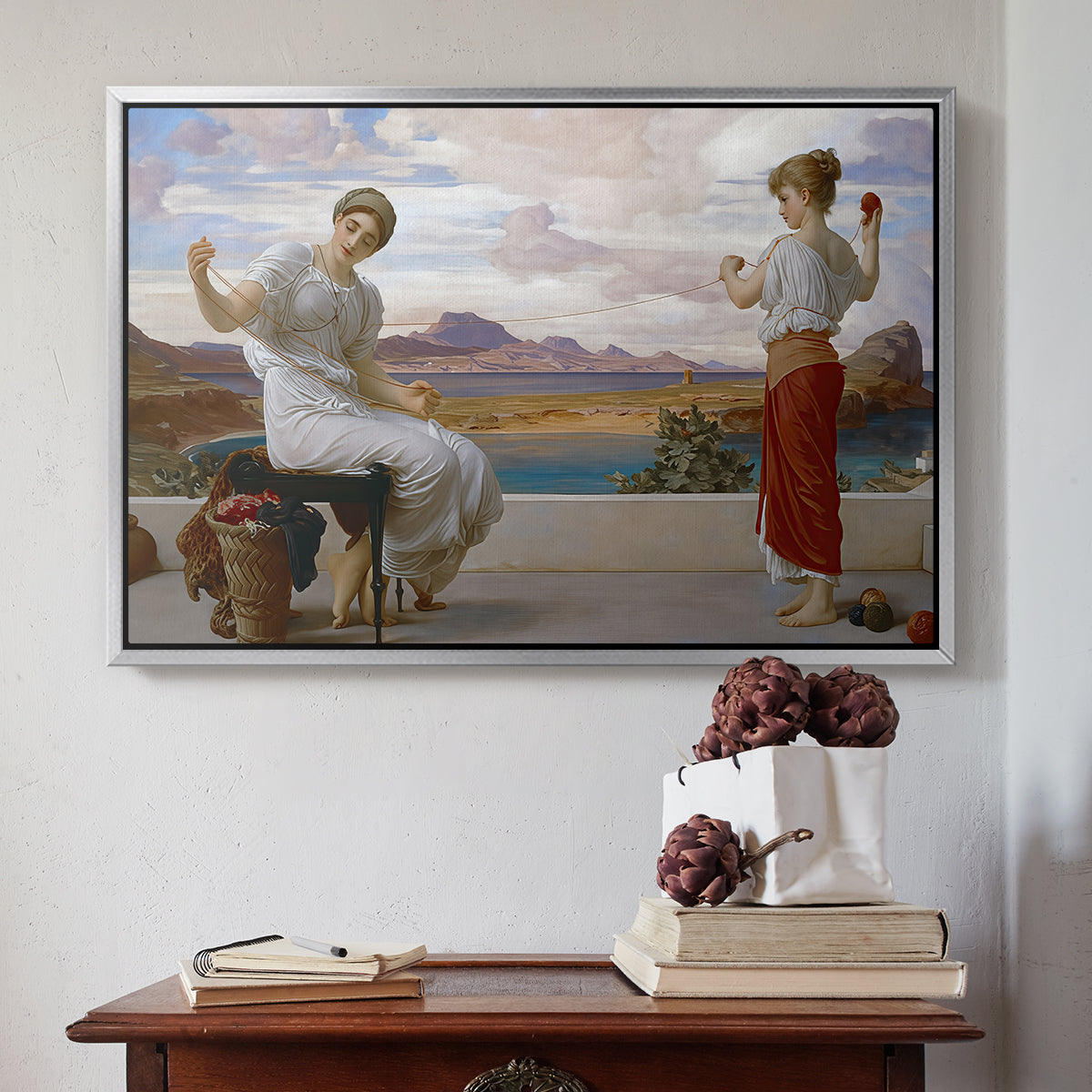 Silver floater framed canvas featuring Winding the Skein, c. 1878 by Frederic Leighton above an entryway table in a minimalist foyer.
