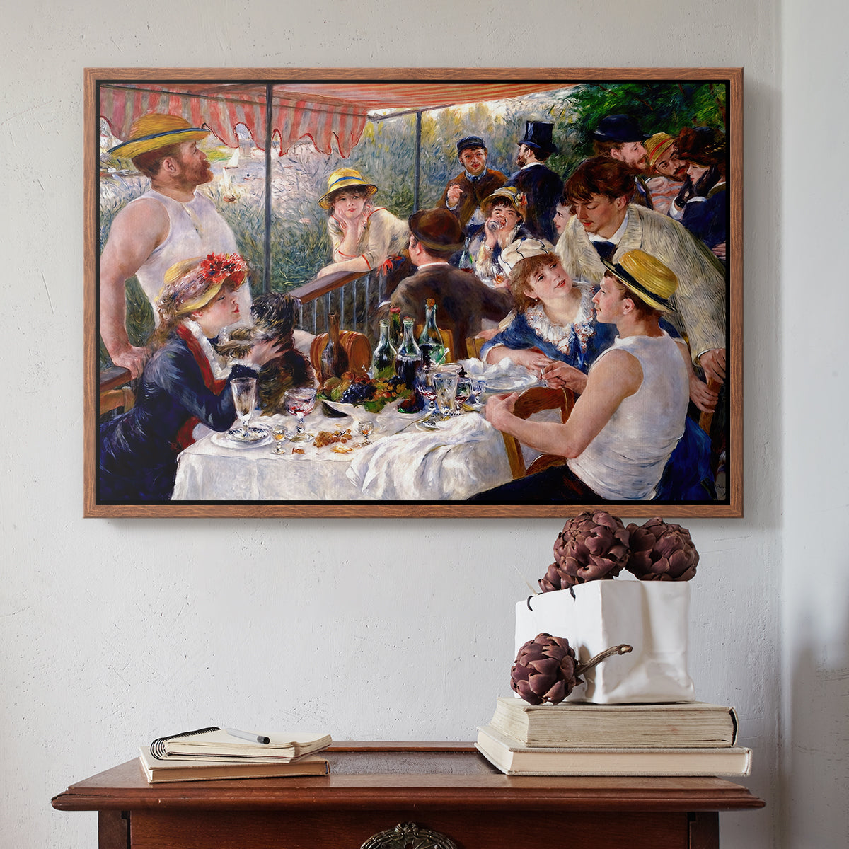 Walnut floater framed canvas featuring Luncheon of the Boating Party (Le Déjeuner des canotiers), 1880-1881 by Pierre-Auguste Renoir above an entryway table in a minimalist foyer.
