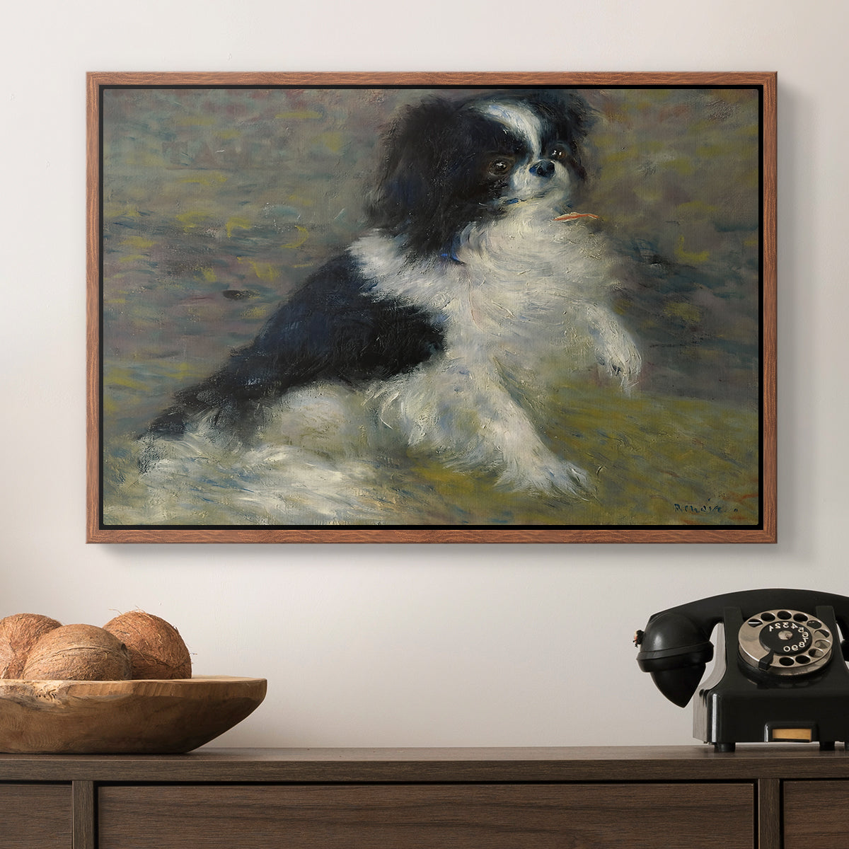 Tama, the Japanese Dog, c. 1876 by Pierre-Auguste Renoir in a walnut floater framed canvas displayed above a console table in a hallway, featuring an animal portrait of a dog in natural outdoor setting with soft light.