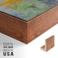 Close-up of the walnut floater frame corner and gallery wrapped canvas construction.