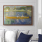 The Skiff (La Yole), 1875 by Pierre-Auguste Renoir displayed above a sofa in a living room in a walnut floater frame, featuring an impressionist boating scene with people relaxing in a narrow skiff.