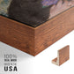 Close-up of the walnut floater frame corner and gallery wrapped canvas construction.