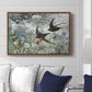 Common Swifts, 1886 by Bruno Liljefors displayed above a sofa in a living room in a walnut floater frame, featuring swifts gliding midair with wings spread against soft sky.