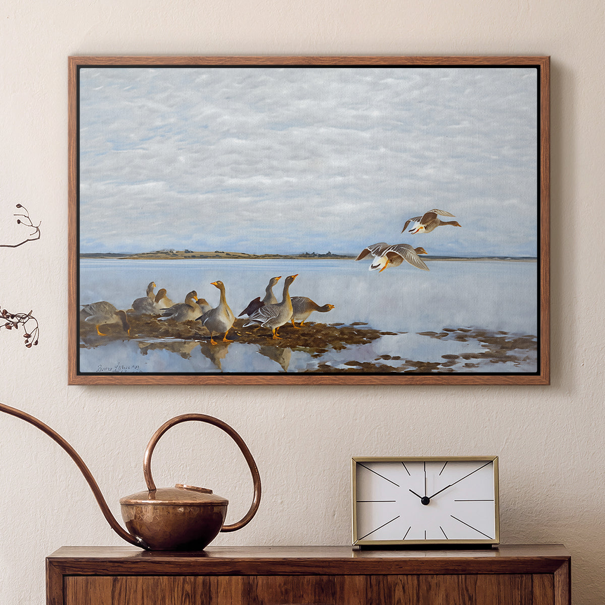 Walnut floater framed canvas featuring a realistic wildlife scene of geese in calm outdoor environment, displayed above a cabinet in a soft-toned living room.