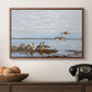 Greylag Geese (Grågäss), 1922 by Bruno Liljefors in a walnut floater framed canvas displayed above a console table in a hallway, featuring a flock of geese positioned along marshy terrain.