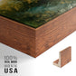 Close-up of the walnut floater frame corner and gallery wrapped canvas construction.