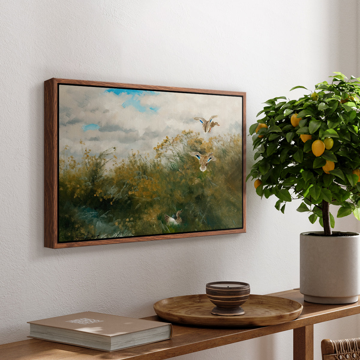 Wild Ducks (Grasänder), 1890 by Bruno Liljefors, presented in a walnut floater framed canvas featuring ducks moving through grassy wetland near water's edge, displayed above a hallway console table.