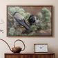 Walnut floater framed canvas featuring a realistic scene of crows interacting on grassy terrain, displayed above a cabinet in a soft-toned living room.
