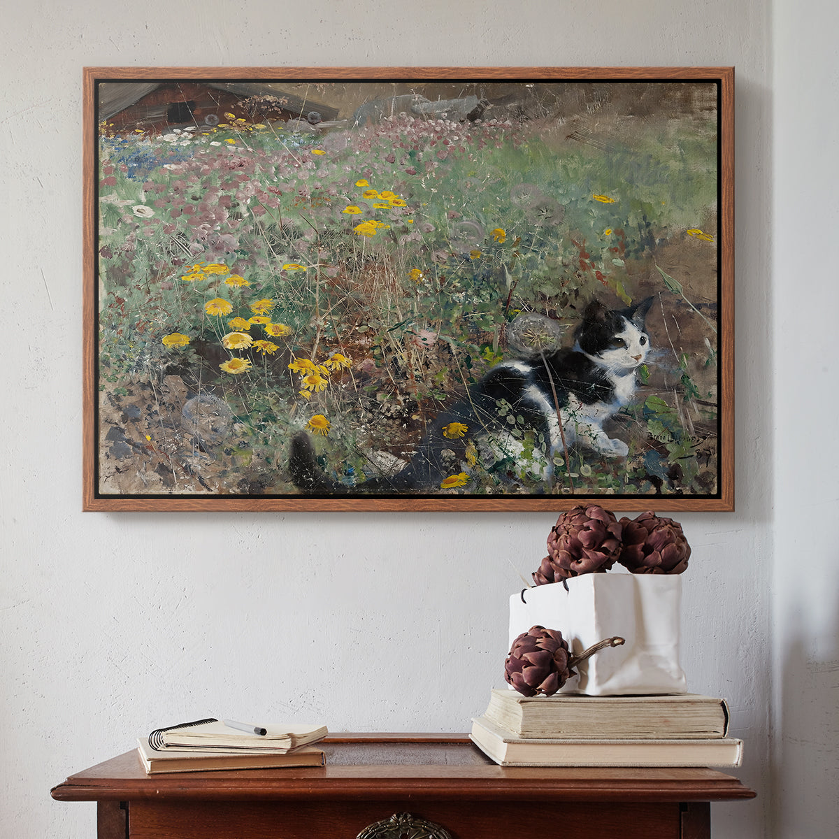 Walnut floater framed canvas featuring Cat on a Flowery Meadow, 1887 by Bruno Liljefors above an entryway table in a minimalist foyer.