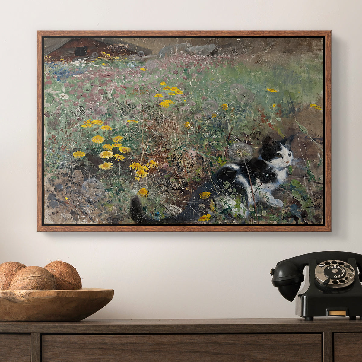 Cat on a Flowery Meadow, 1887 by Bruno Liljefors in a walnut floater framed canvas displayed above a console table in a hallway, featuring a naturalistic depiction of cat in blooming countryside setting.