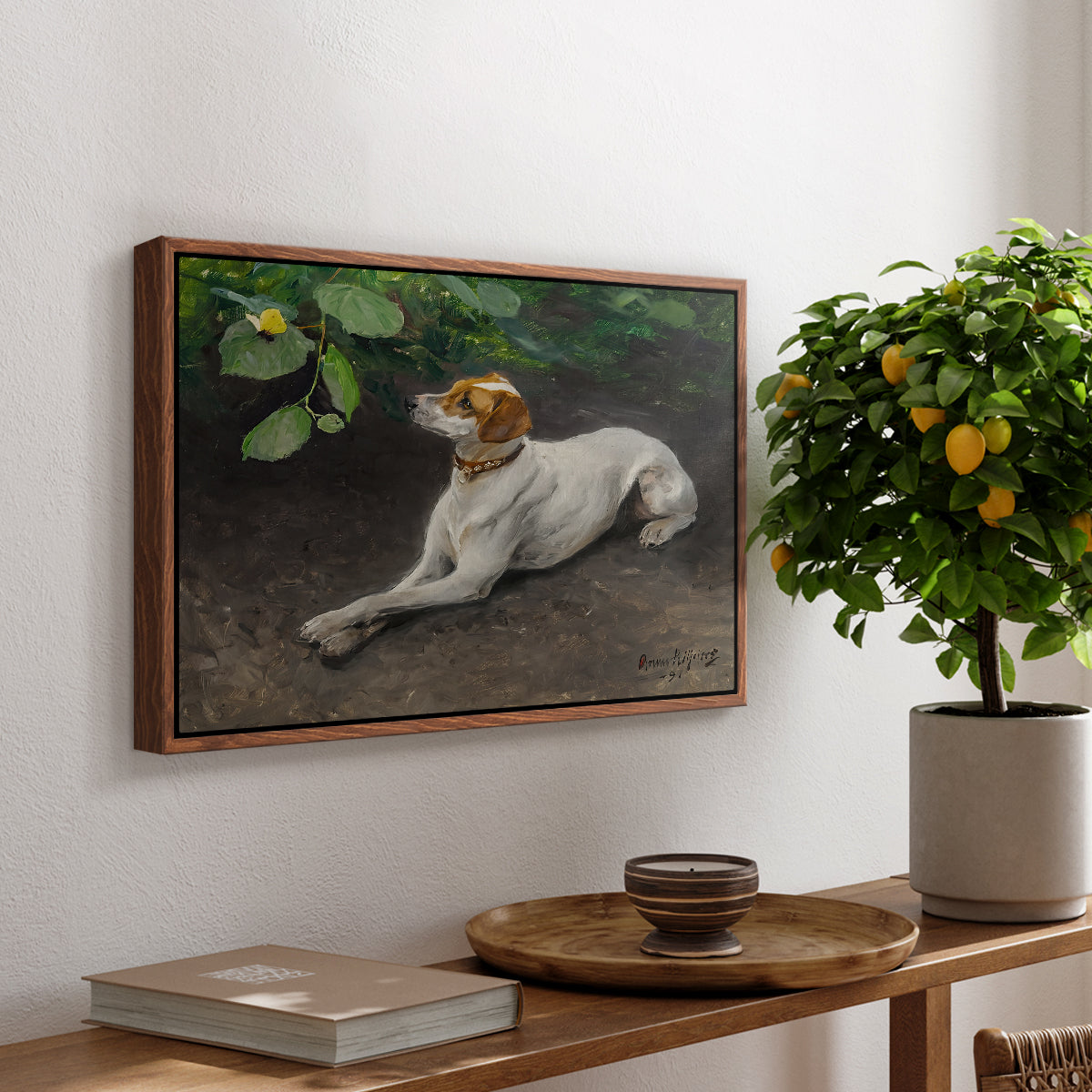 Portrait of a Dog, 1891 by Bruno Liljefors, presented in a walnut floater framed canvas featuring a dog lying on ground with head raised in natural outdoor setting, displayed above a hallway console table.
