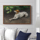 Portrait of a Dog, 1891 by Bruno Liljefors displayed above a sofa in a living room in a walnut floater frame, featuring a realistic portrait of a resting dog with attentive expression.