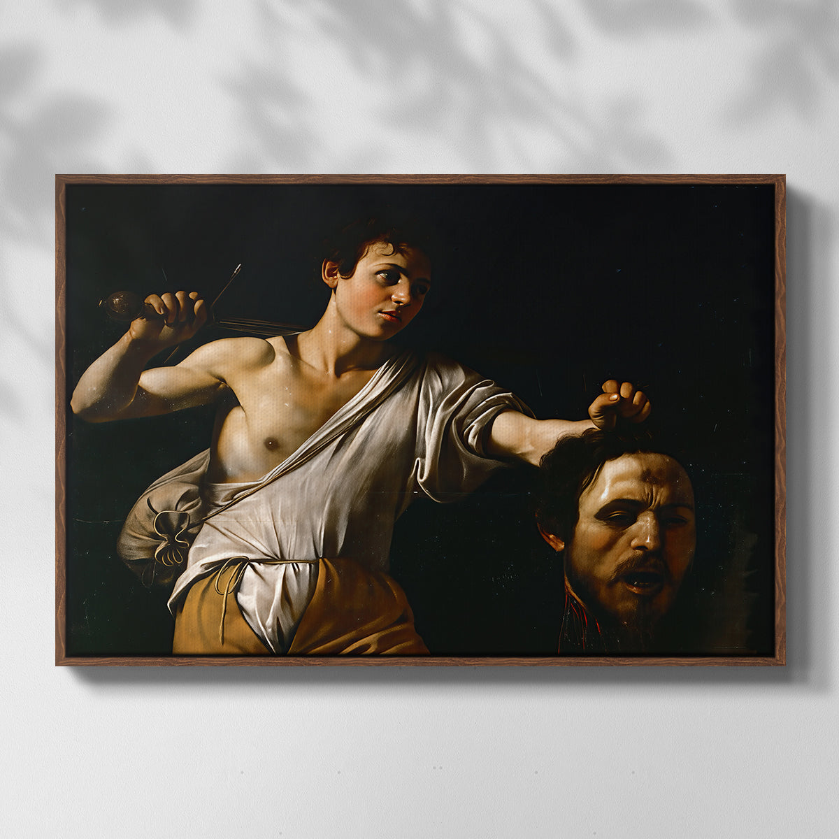 Front view of David with the Head of Goliath (Vienna Version), c. 1607 by Caravaggio in a walnut floater framed canvas.