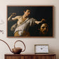 Walnut floater framed canvas featuring a Baroque depiction of youth holding severed head in shadowy setting, displayed above a cabinet in a soft-toned living room.