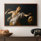David with the Head of Goliath (Vienna Version), c. 1607 by Caravaggio in a walnut floater framed canvas displayed above a console table in a hallway, featuring an intense religious scene with figure emerging from darkness holding trophy.