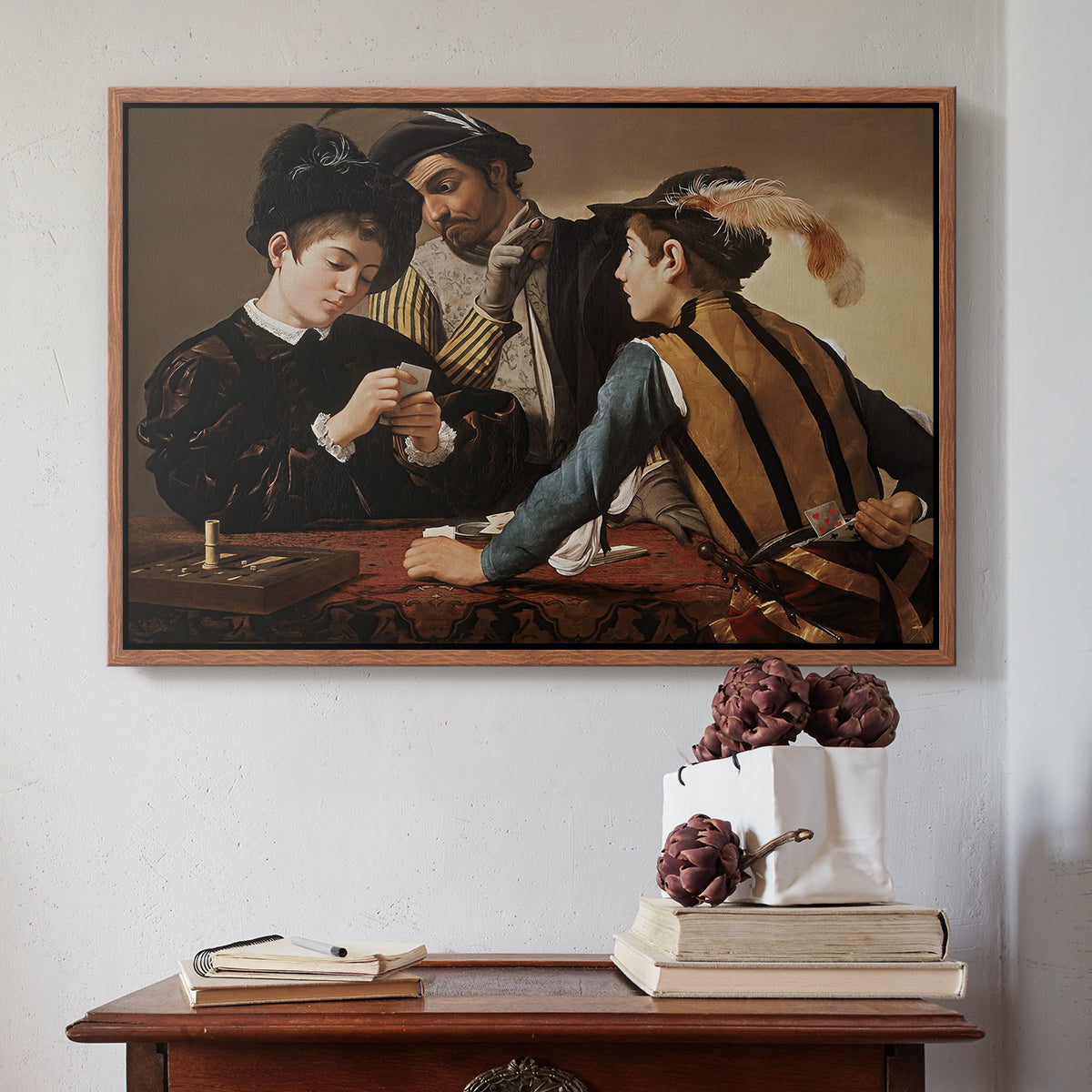 Walnut floater framed canvas featuring The Cardsharps, c. 1594 by Caravaggio above an entryway table in a minimalist foyer.