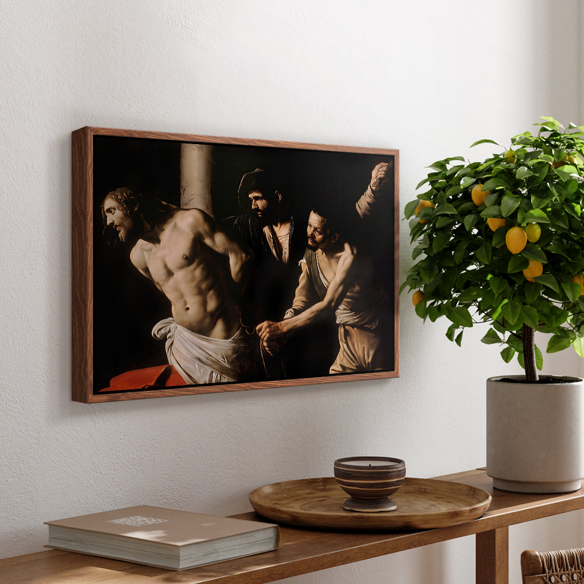 The Flagellation of Christ at the Column (Rouen Version), 1606 by Caravaggio, presented in a walnut floater framed canvas featuring Christ bound to column while being whipped by surrounding figures, displayed above a hallway console table.