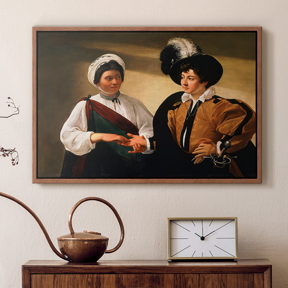 Walnut floater framed canvas featuring an intimate scene of palm reading with subtle act of theft, displayed above a cabinet in a soft-toned living room.