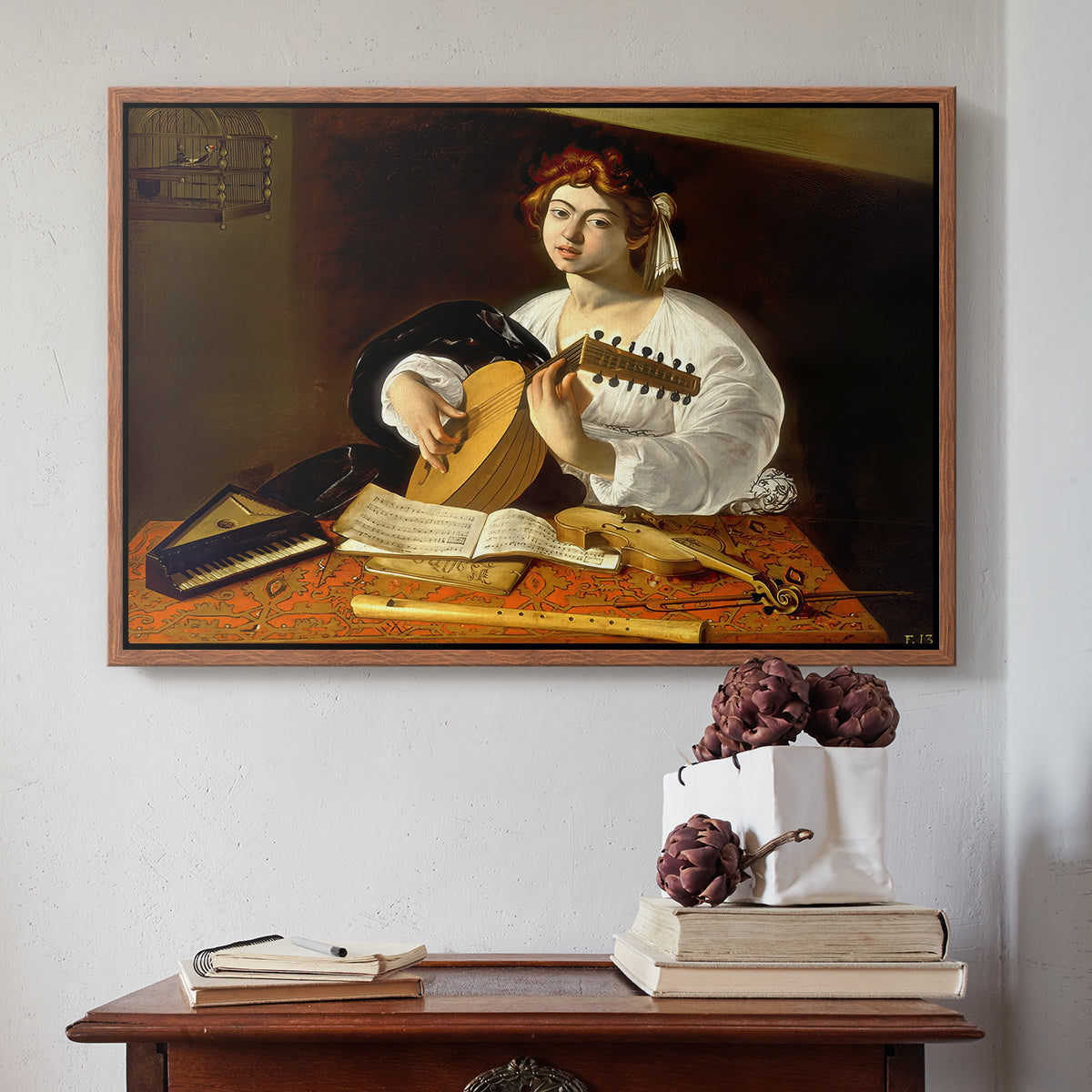 Walnut floater framed canvas featuring The Lute Player (Wildenstein Version), c. 1596 by Caravaggio above an entryway table in a minimalist foyer.