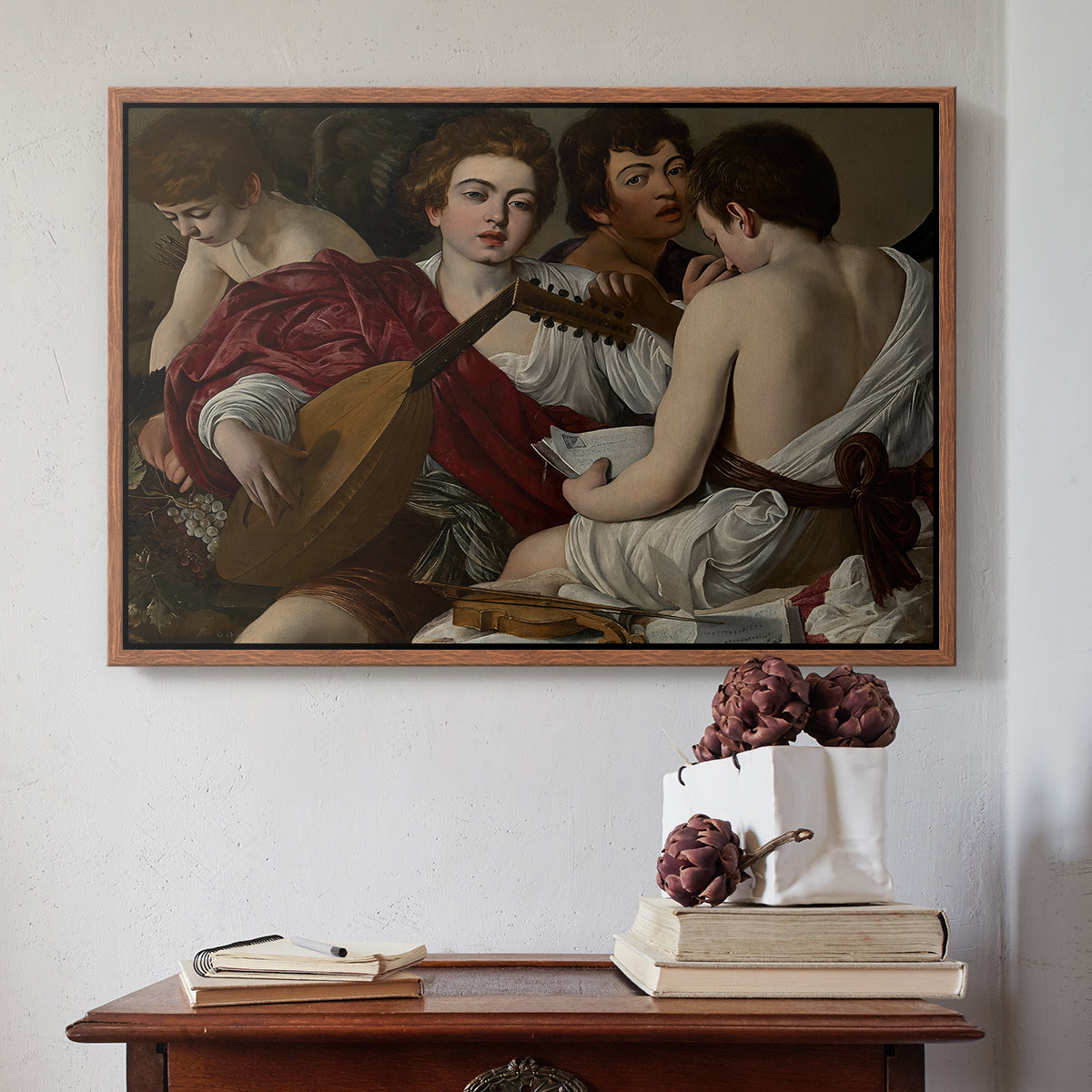 Walnut floater framed canvas featuring The Musicians, c. 1595 by Caravaggio above an entryway table in a minimalist foyer.