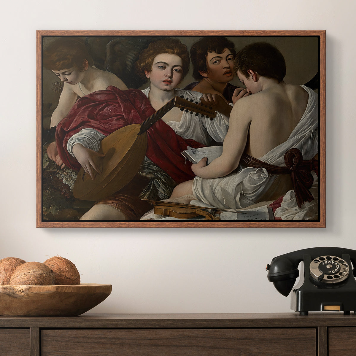 The Musicians, c. 1595 by Caravaggio in a walnut floater framed canvas displayed above a console table in a hallway, featuring a musical gathering with figures posed closely in soft light.