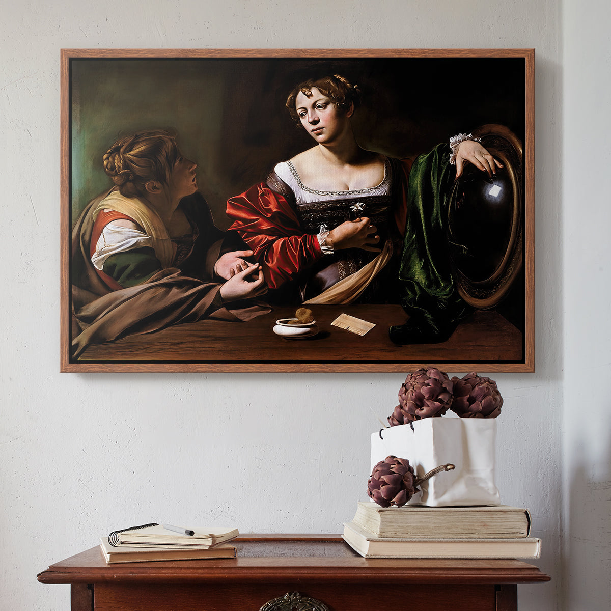 Walnut floater framed canvas featuring Martha and Mary Magdalene, c. 1598 by Caravaggio above an entryway table in a minimalist foyer.