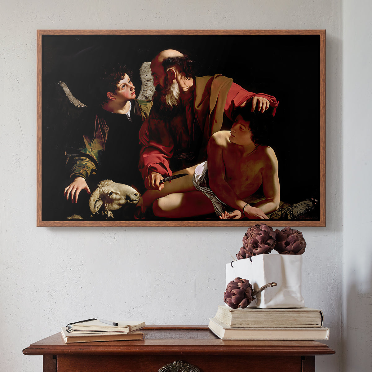 Walnut floater framed canvas featuring The Sacrifice of Isaac (Uffizi Version), c. 1603 by Caravaggio above an entryway table in a minimalist foyer.