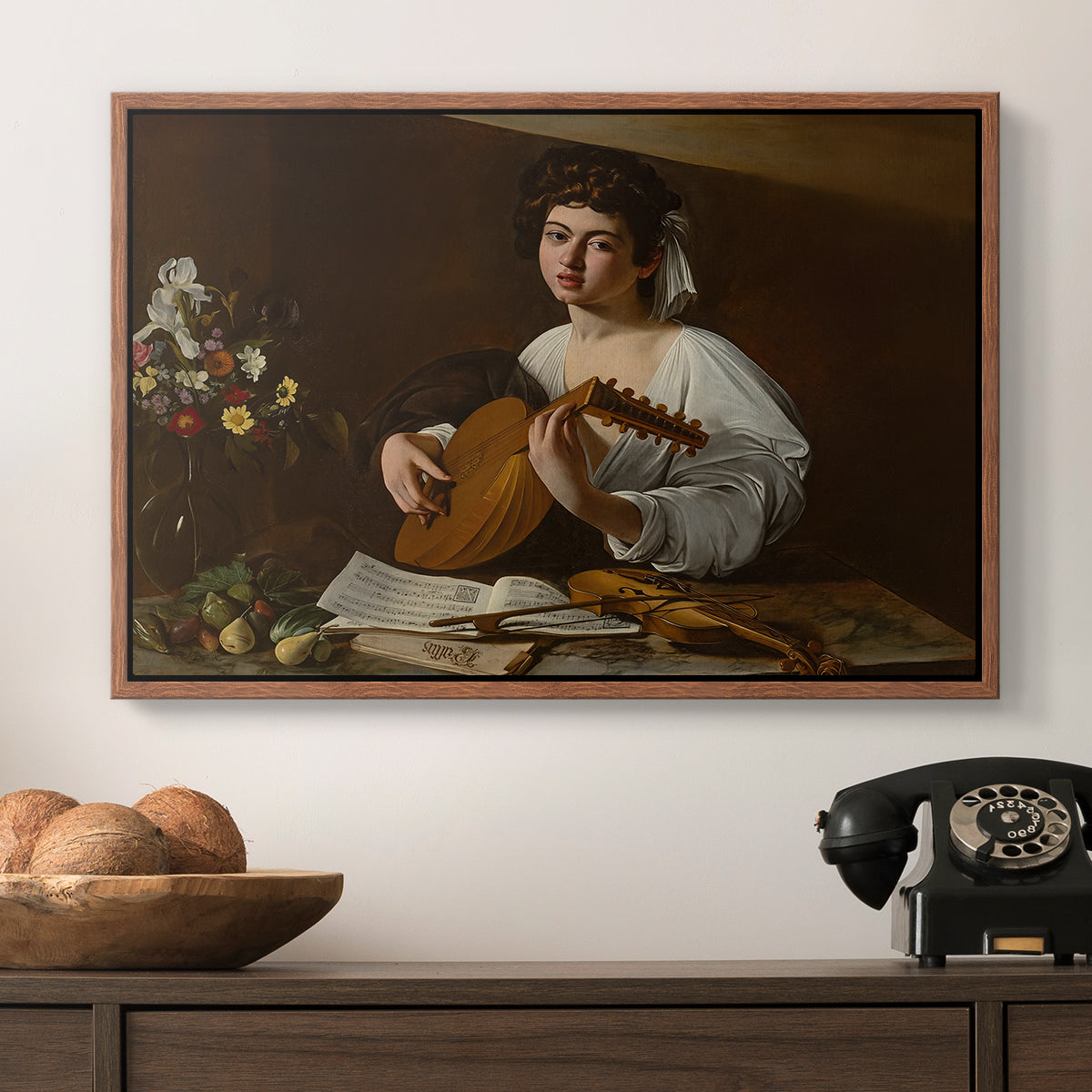 The Lute Player (Hermitage Version), c. 1596 by Caravaggio in a walnut floater framed canvas displayed above a console table in a hallway, featuring a Baroque depiction of musician with detailed textures and lighting.