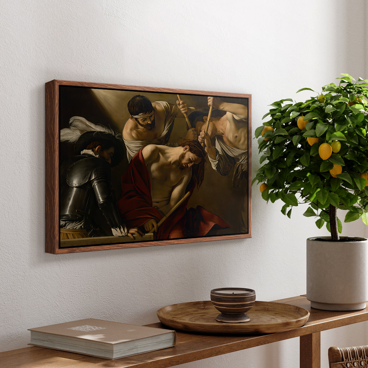 The Crowning with Thorns (Vienna Version), c. 1602-1604 by Caravaggio, presented in a walnut floater framed canvas featuring Christ surrounded by men pressing crown of thorns onto his head, displayed above a hallway console table.