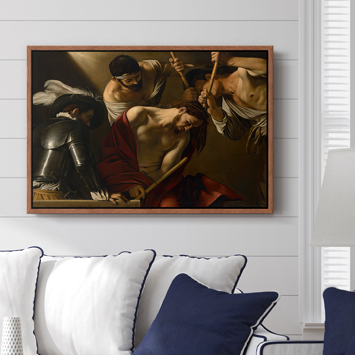 The Crowning with Thorns (Vienna Version), c. 1602-1604 by Caravaggio displayed above a sofa in a living room in a walnut floater frame, featuring a biblical scene of Christ being mocked and crowned with thorns.