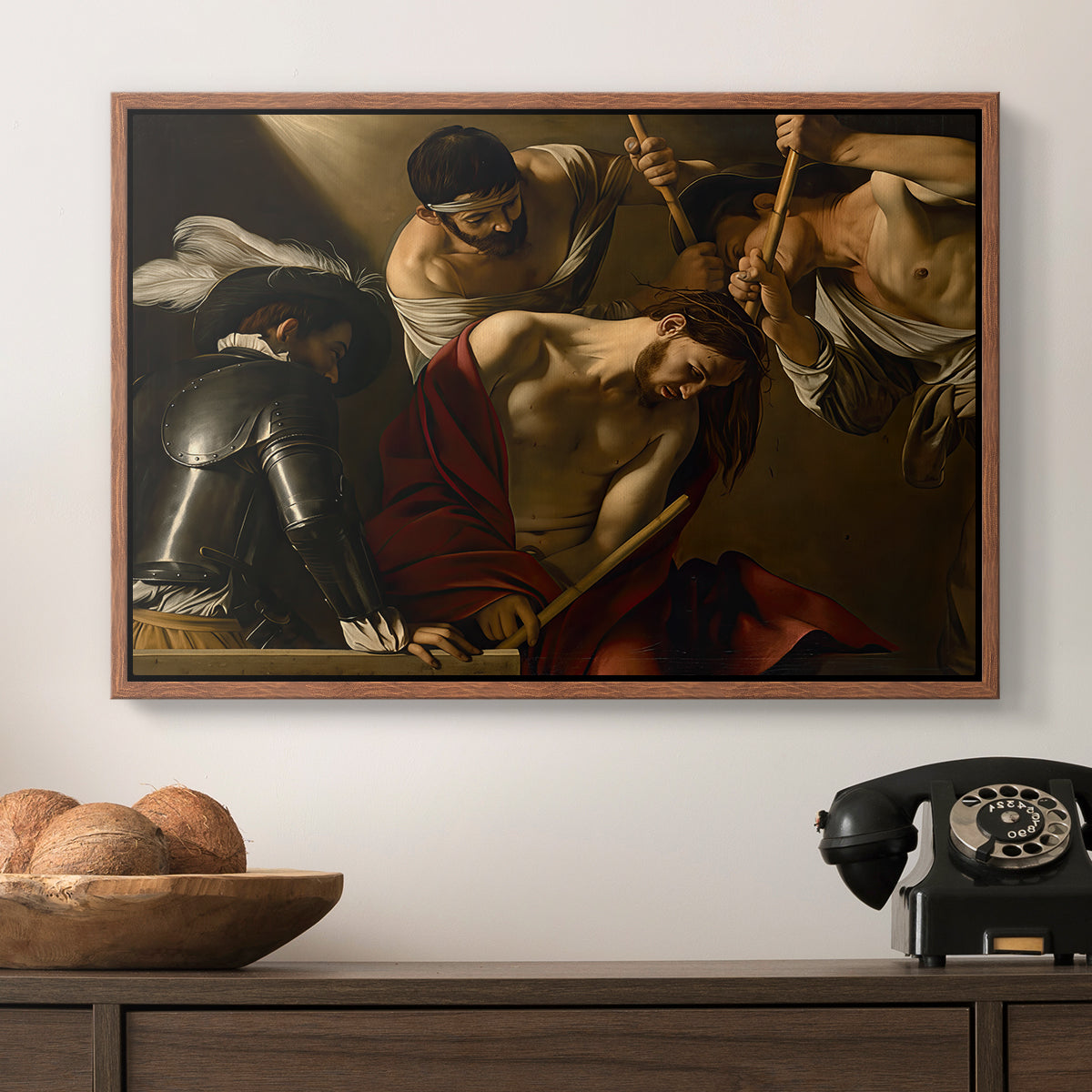 The Crowning with Thorns (Vienna Version), c. 1602-1604 by Caravaggio in a walnut floater framed canvas displayed above a console table in a hallway, featuring an intense religious composition with strong shadow and physical struggle.