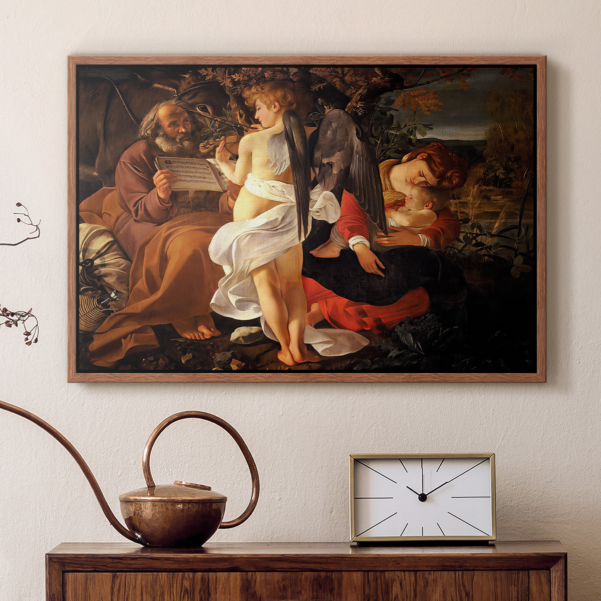 Walnut floater framed canvas featuring a peaceful religious moment with figures reclining in natural setting, displayed above a cabinet in a soft-toned living room.