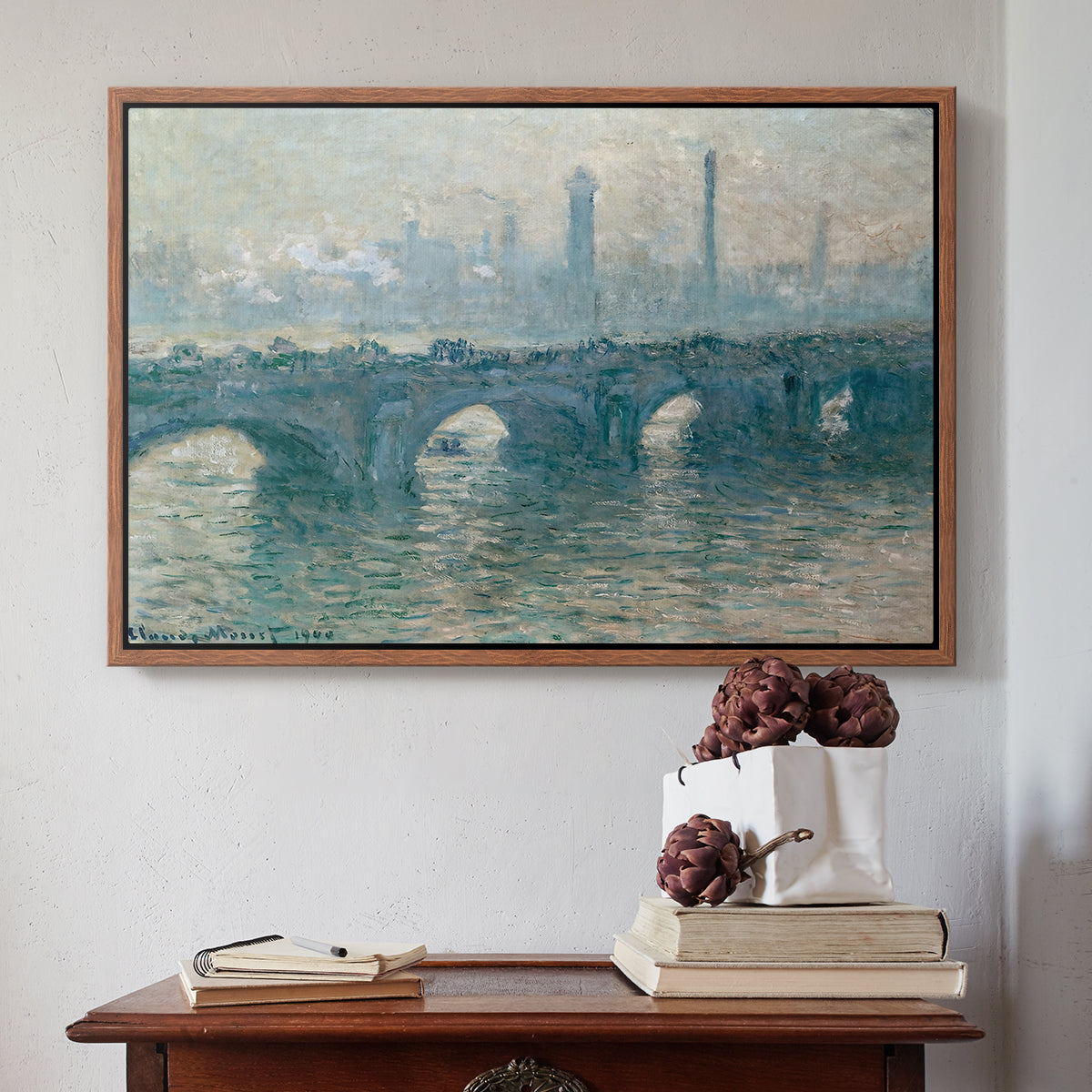 Walnut floater framed canvas featuring Waterloo Bridge, Gray Weather, 1900 by Claude Monet above an entryway table in a minimalist foyer.