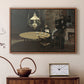 Walnut floater framed canvas featuring an impressionist interior showing aftermath of dinner with soft light, displayed above a cabinet in a soft-toned living room.