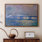 Walnut floater framed canvas featuring an atmospheric depiction of London bridge with reflections in water, displayed above a cabinet in a soft-toned living room.