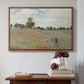 Walnut floater framed canvas featuring The Poppy Field near Argenteuil, 1873 by Claude Monet above an entryway table in a minimalist foyer.