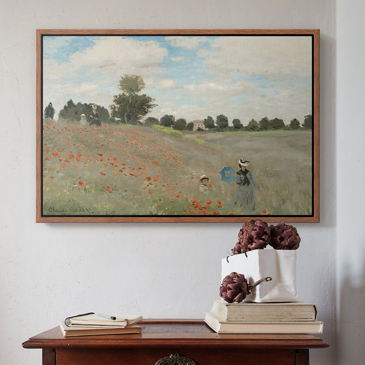 Walnut floater framed canvas featuring The Poppy Field near Argenteuil, 1873 by Claude Monet above an entryway table in a minimalist foyer.