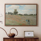 Walnut floater framed canvas featuring a bright meadow filled with poppies under open sky, displayed above a cabinet in a soft-toned living room.