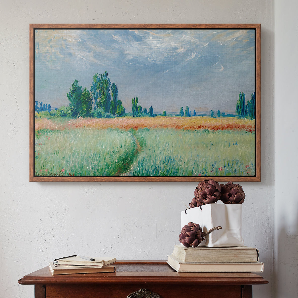 Walnut floater framed canvas featuring The Wheat Field (Champ de Blé), 1881 by Claude Monet above an entryway table in a minimalist foyer.