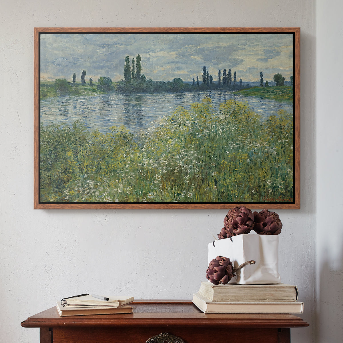 Walnut floater framed canvas featuring Banks of the Seine, Vétheuil, 1880 by Claude Monet above an entryway table in a minimalist foyer.