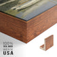 Close-up of the walnut floater frame corner and gallery wrapped canvas construction.