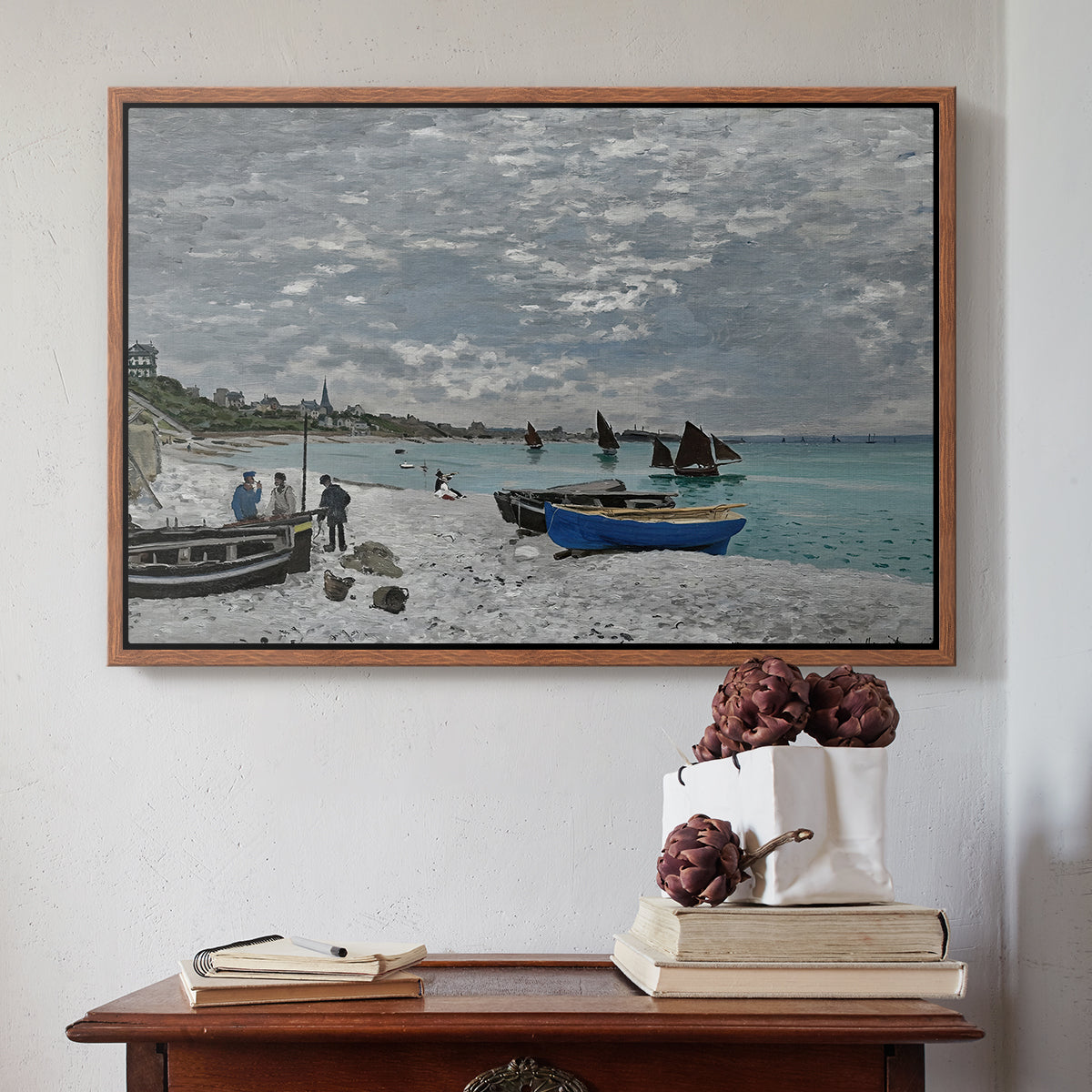 Walnut floater framed canvas featuring The Beach at Sainte-Adresse, 1867 by Claude Monet above an entryway table in a minimalist foyer.